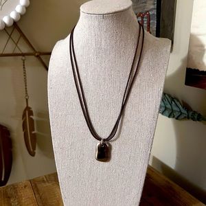 Carolee choker with small silver toned pendant on brown leather cord